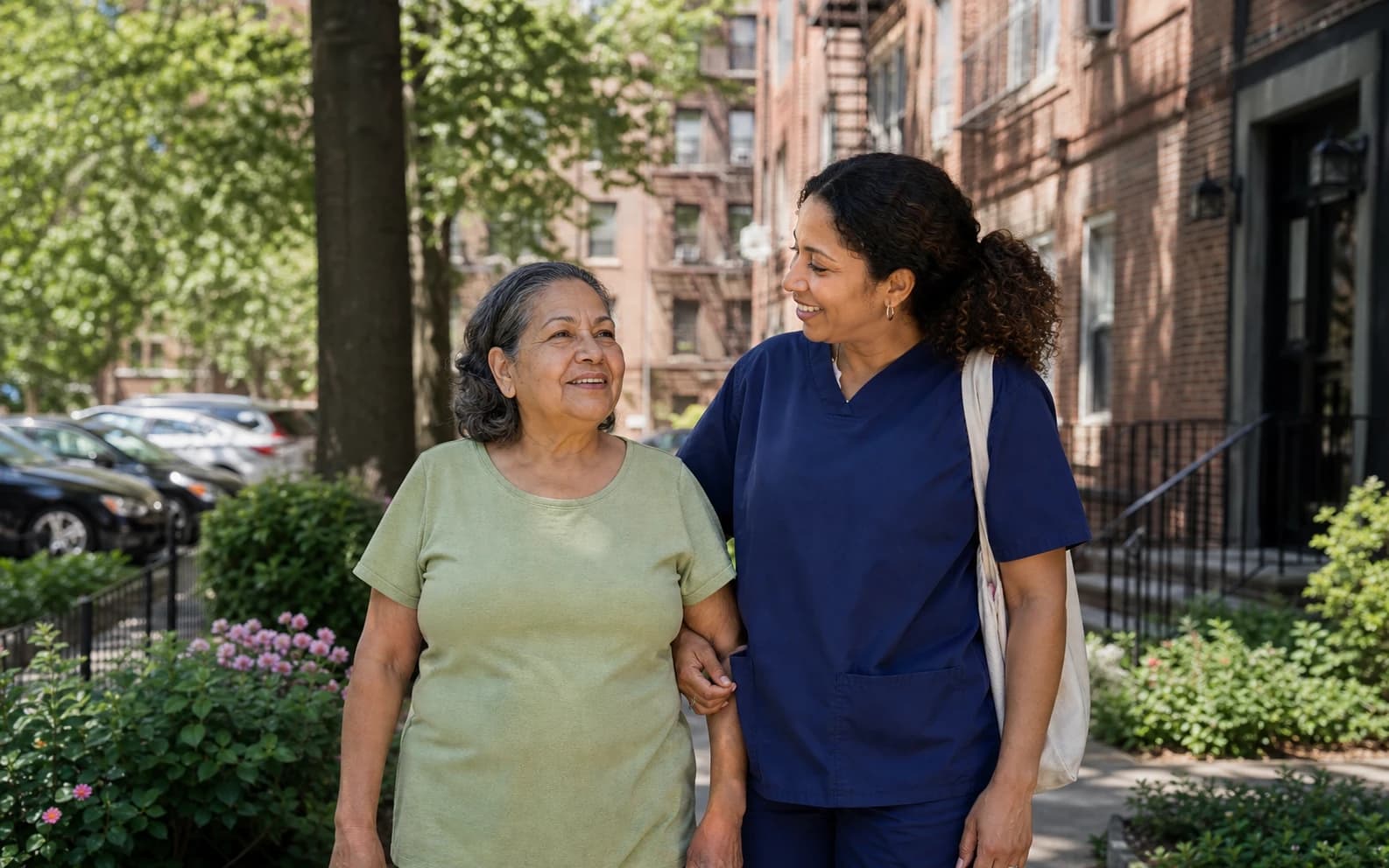 A senior caregiver walking with an older woman outside her home in Clayton County, GA